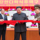 Kim Jong Un, second right, cuts the ribbon during an inauguration ceremony of Pothong riverside terraced residential district in Pyongyang, North Korea on April 13, 2022.